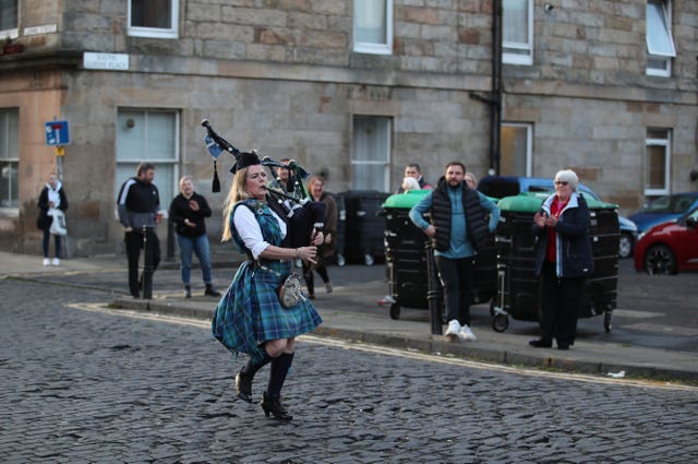 Piper Louise Marshall performs in Leith, Edinburgh, during Thursday’s nationwide clap for carers