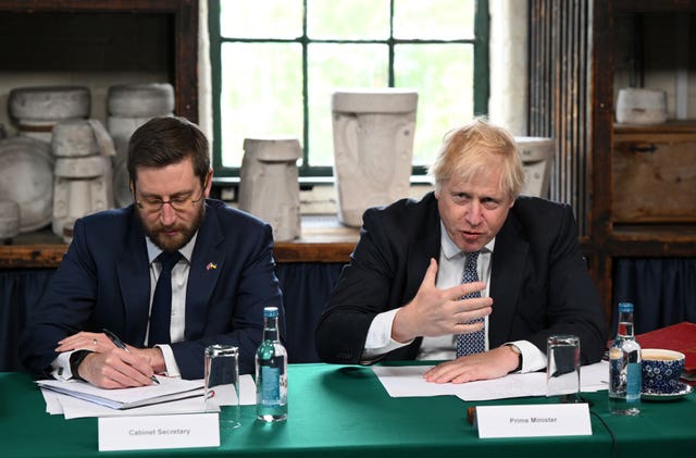 Prime Minister Boris Johnson (right) and Cabinet Secretary Simon Case during a regional had a WhatsApp conversation when news emerged of so-called partygate (Oli Scarff/PA)