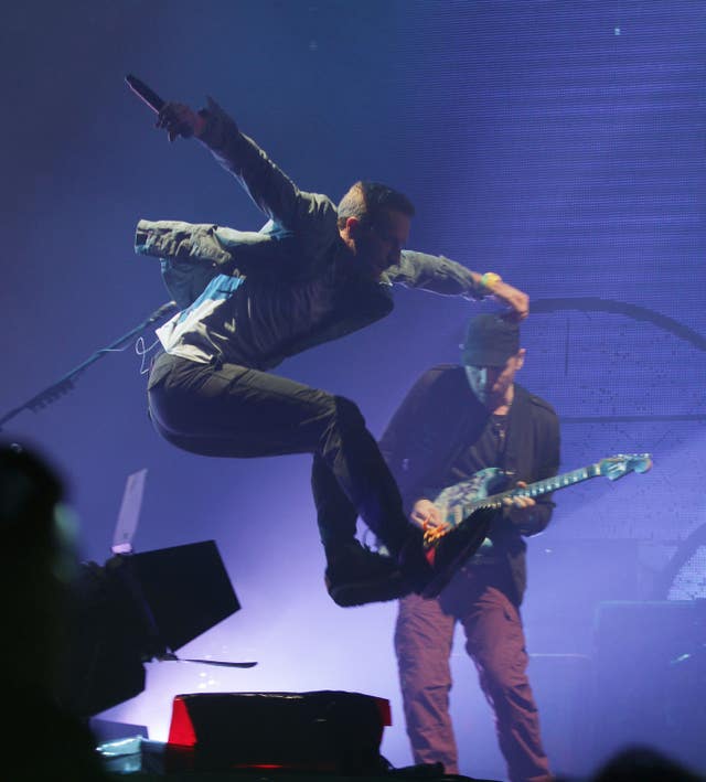 Chris Martin of Coldplay jumps as he performs at Glastonbury in 2011