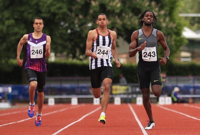 Ricardo Dos Santos running on a track with two fellow athletes.