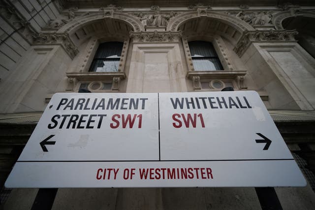 A street sign giving directions to Parliament Street and Whitehall