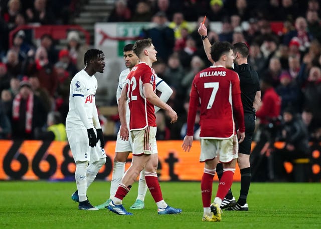 Jarred Gillett shows a red card to Yves Bissouma