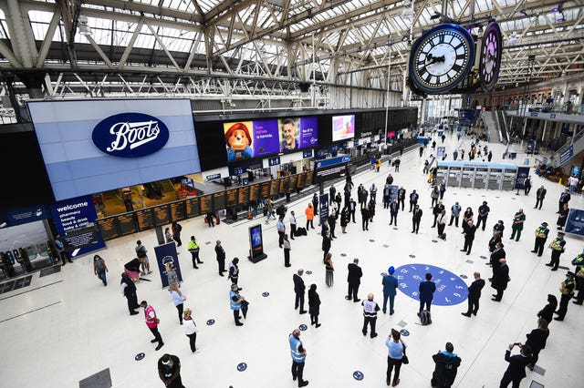 Rail staff stand pay tribute at London's Waterloo station 