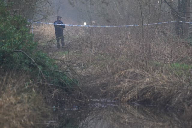 A police officer stands at a cordon close to the scene of the stabbing