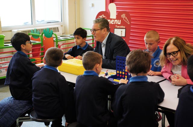 Prime Minister Sir Keir Starmer speaks to children during a visit to St Michael’s Junior School in Bath following the rollout of 750 new free breakfast clubs across England