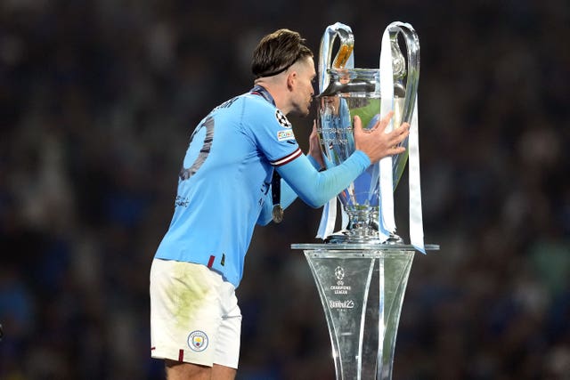 Jack Grealish kisses the Champions League trophy
