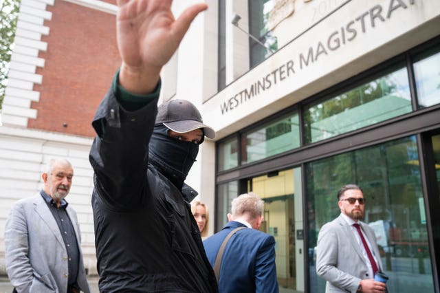 Metropolitan Police officer Thomas Phillips, with his face covered, arrives at Westminster Magistrates’ Court, London, for sentencing