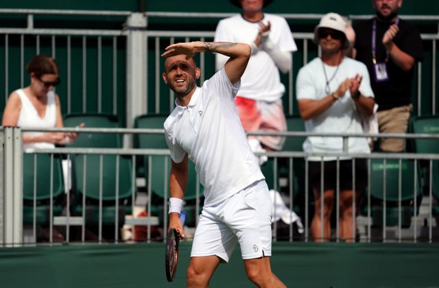 Dan Evans shields his eyes from the sun