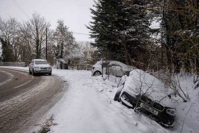 Abandoned cars in a snow-filled ditch in Needham Market, Suffolk