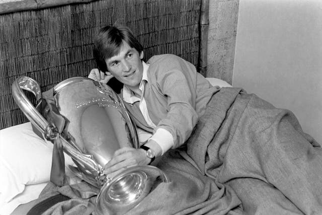 Kenny Dalglish wakes up with the European Cup trophy the next morning