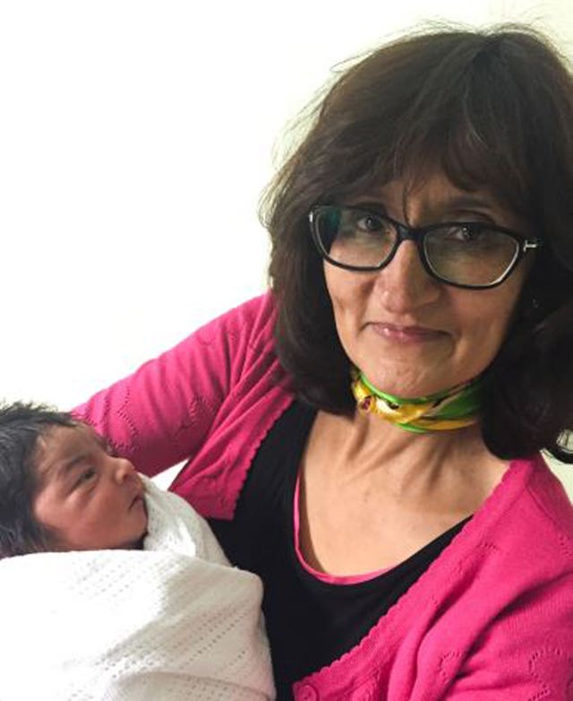 Anita Mukhey holding a baby