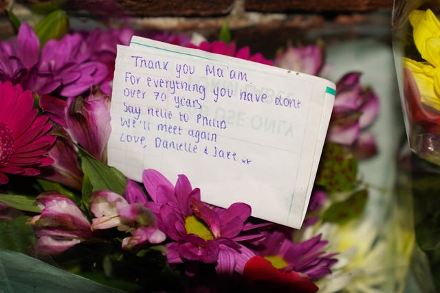 Floral tributes and messages at the gates of Sandringham House