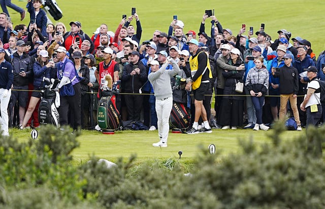 Fans watch Rory McIlroy play a shot