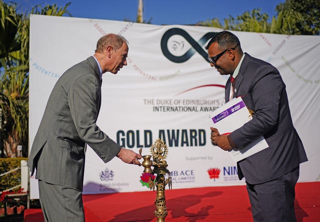 The Duke of Edinburgh (left) and the chair of the Duke of Edinburgh International Award Nepal, Dev Raj Ghimire, light a lamp ahead of an awards ceremony at the British embassy