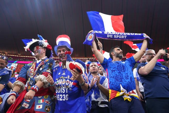 France fans wave flags and scarves before the FIFA World Cup Semi-Final match at the Al Bayt Stadium in Al Khor, Qatar 