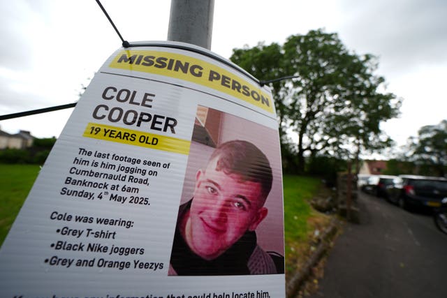 A missing person poster featuring Cole Cooper on a lamppost