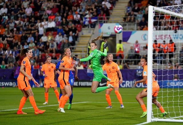 Daphne van Domselaar, centre, saves from France's Wendie Renard, not pictured