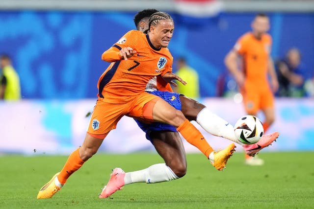Netherlands midfielder Xavi Simons challenges France counterpart Aurelien Tchouameni during a match at Euro 2024