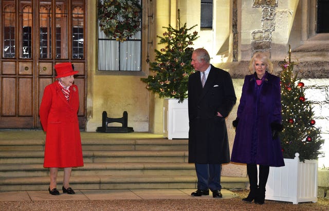 Queen Elizabeth II stands with the Prince of Wales and the Duchess of Cornwall, in the quadrangle at Windsor Castle