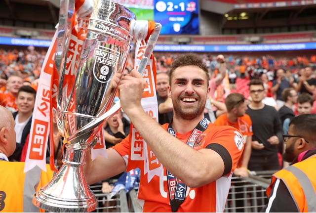 Blackpool’s Clark Robertson celebrates with the trophy