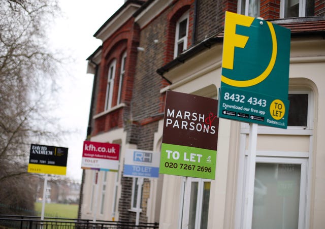 A row of estate agent letting signs placed outside houses in north London