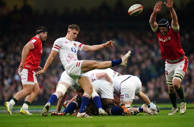 England’s Jack van Poortvliet kicks the ball as a Welsh opponent looks to charge down the kick