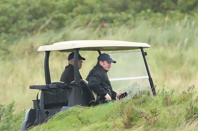 The Duke of York being driven in a golf buggy