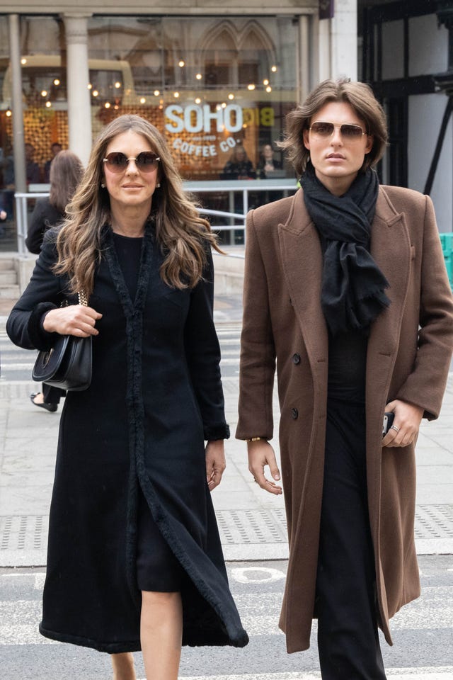 Liz and Damian Hurley walking outside