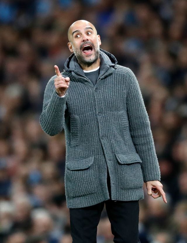 Pep Guardiola gestures on the touchline 