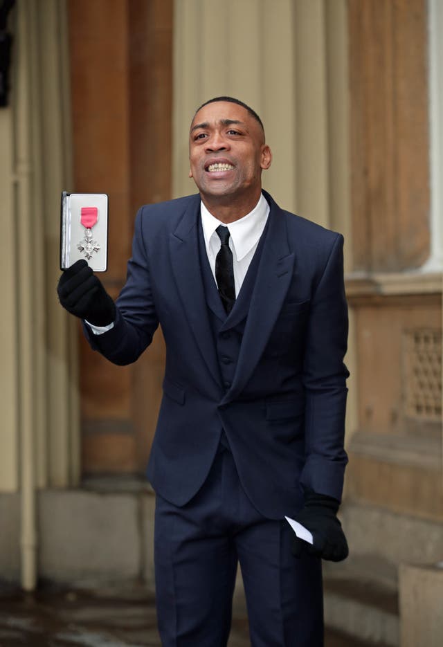 Wiley holds his MBE at Buckingham Palace.