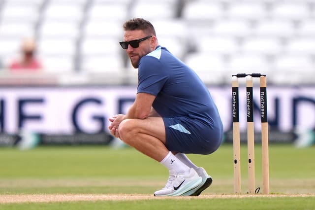 Brendon McCullum crouches next to the wicket during an England training session