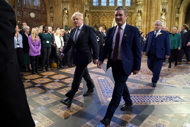 Prime Minister Boris Johnson (left) and the leader of the Labour Party Keir Starmer walk through the Central Lobby at the Palace of Westminster ahead of the State Opening of Parliament in the House of Lords, London