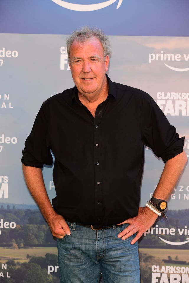 Jeremy Clarkson standing with his hands on his hips, dressed in black shirt and jeans
