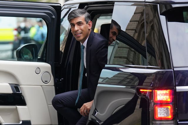 Rishi Sunak getting out of a vehicle as he arrives for the election event