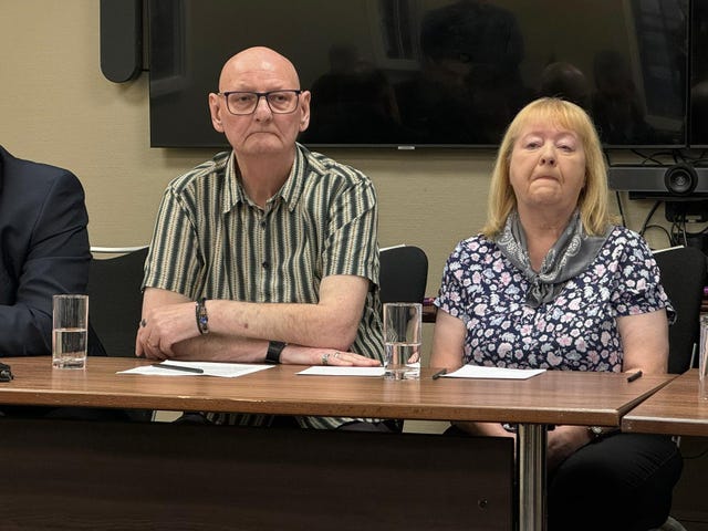 Peter and Florence Fanning sitting at a table, facing the same way