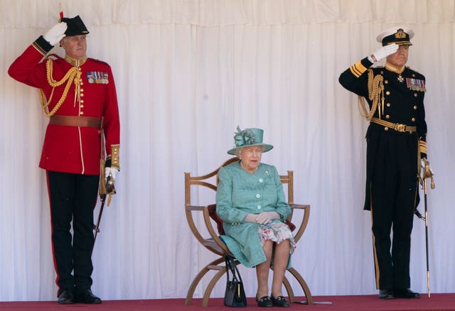 The Queen watching last year's military ceremony that marked her official birthday