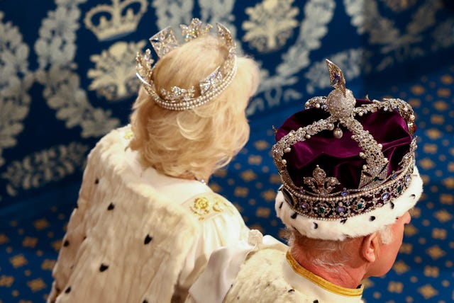 The back of the King and Queen's heads as they wear their crowns