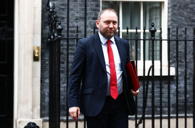 Ian Murray in suit and tie, with red folder under his arm, outside Number 10