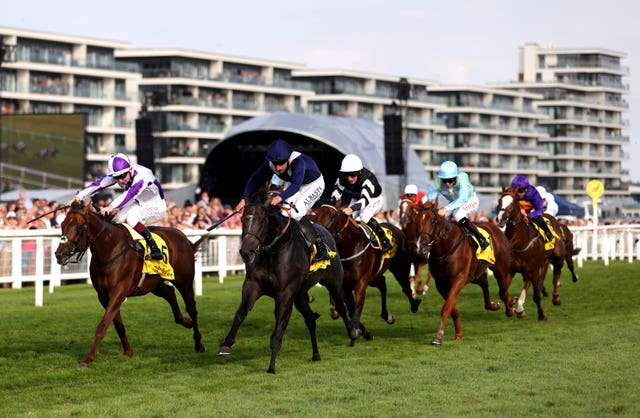 Wings Of War ridden by Adam Kirby (second left) wins the Mill Reef Stakes from Hierarchy (left) 