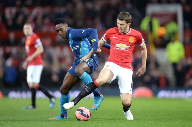 Michael Carrick (right) and Danny Welbeck (left) battle for the ball
