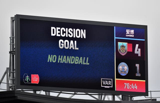 A VAR decision on handball is displayed on a screen at Peterborough 