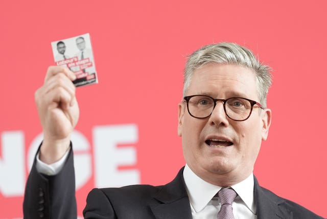 Sir Keir Starmer brandishes his party's 'first steps' card