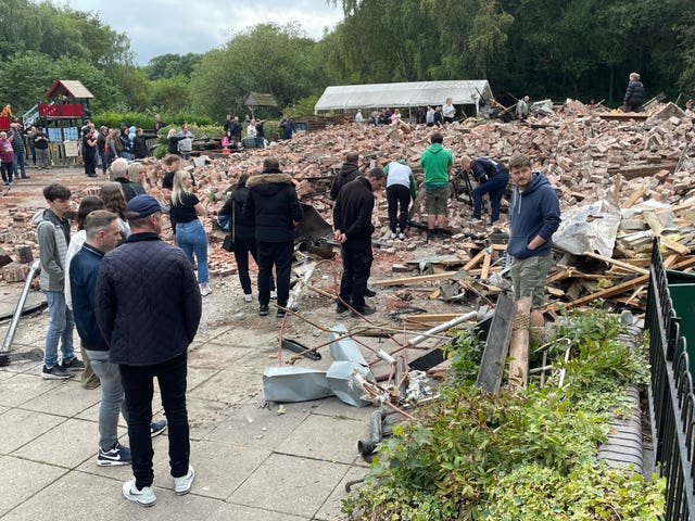 People at the remains of the Crooked House