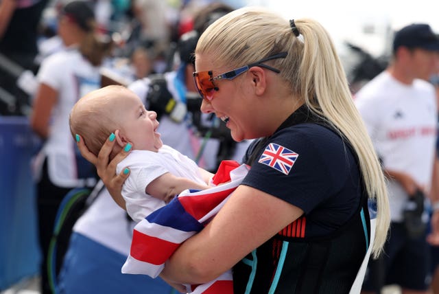 A woman holds a baby in her arms