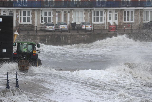 A tractor puts in temporary flood defences in Swanage in Dorset in October