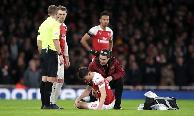 Laurent Koscielny (floor) was injured in the FA Cup defeat to Manchester United