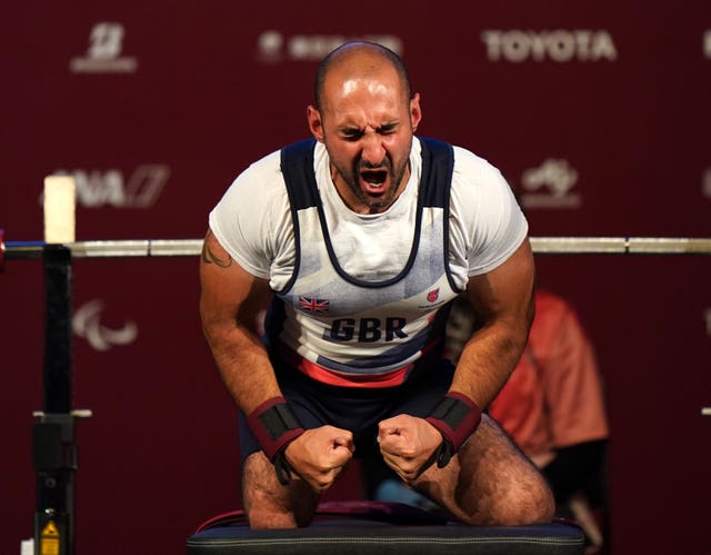 Great Britain's Ali Jawad celebrates after the second lift in the men's -59 kg final