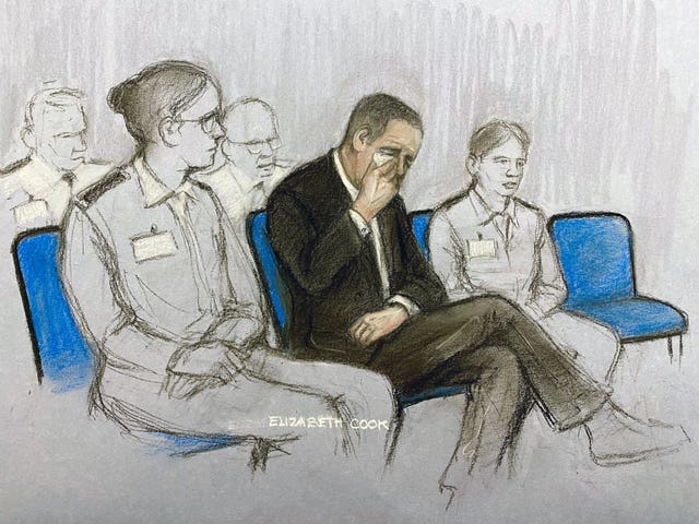 Court artist sketch by Elizabeth Cook of Paul Doyle, wiping away tears as he appears at Liverpool Crown Court