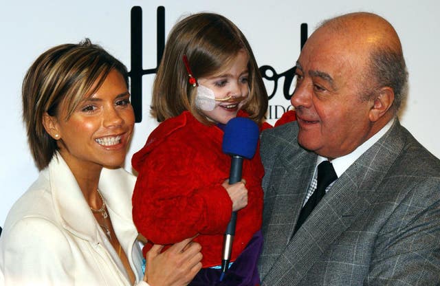 Victoria Beckham and Mohammed Al Fayed help with six-year-old Kirsty Howard from Manchester, who was born with her heart back to front, open the Harrods' January sales in 2002