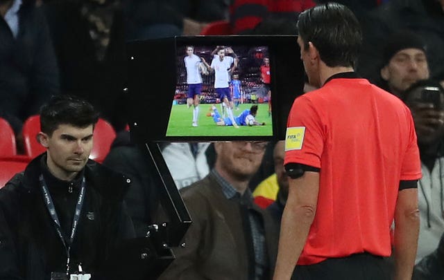 Referee Deniz Aytekin watches the replay of James Tarkowski's challenge